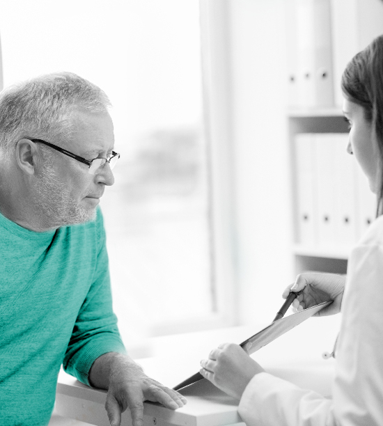 middle aged man reviewing test results with doctor