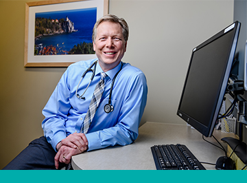 north memorial health family medicine docotor smiling at workstation