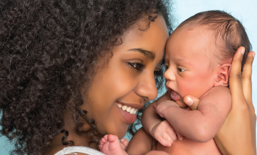 mother embracing newborn baby