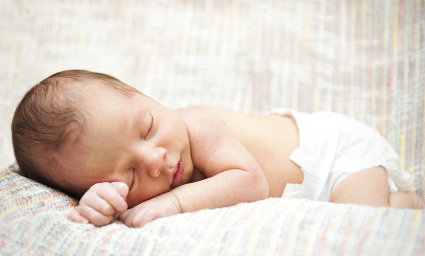 Newborn sleeping on a blanket