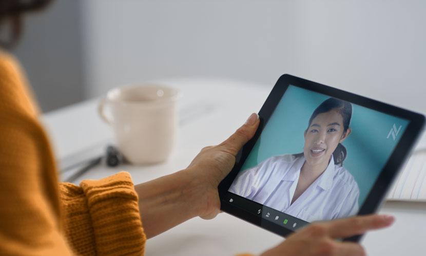 woman holding tablet for virtual doctor visit