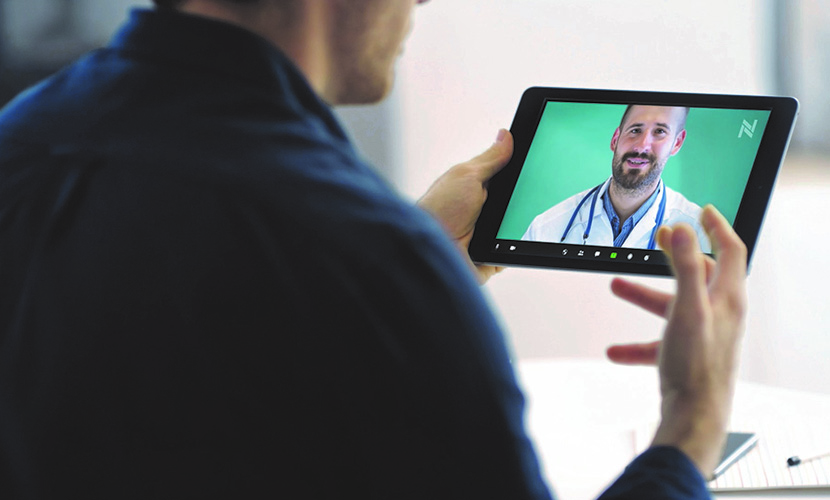 man looking at doctor on tablet