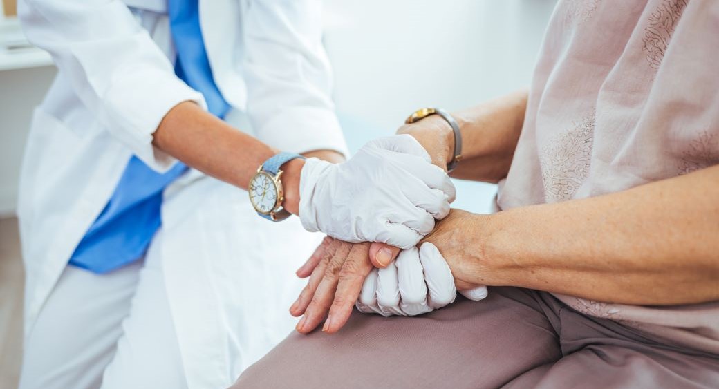 Nurse holding patient's hands